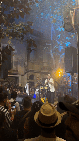 Live music and green paper canopy at Barcelona street festival