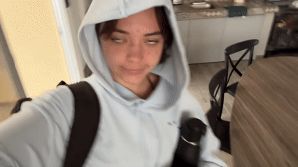 Woman films selfie video in Mexican residential interior