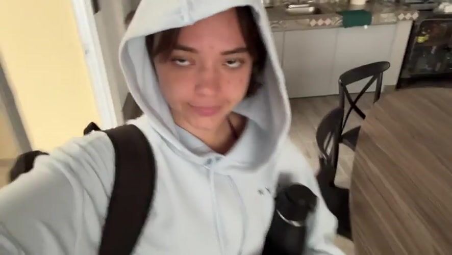 Woman films selfie video in Mexican residential interior