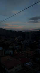 Cable car passenger views La Paz cityscape at dusk