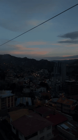 Cable car passenger views La Paz cityscape at dusk