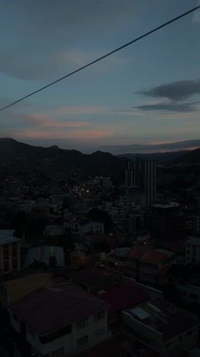 Cable car passenger views La Paz cityscape at dusk