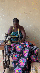 Woman sews floral fabric at vintage machine in Akwanga