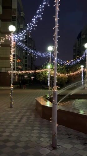 Krasnoyarsk café street and courtyard fountain, summer evening