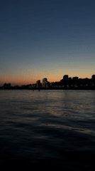Dusk skyline captured over Kazan waterfront with crescent moon