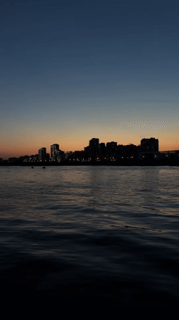 Dusk skyline captured over Kazan waterfront with crescent moon