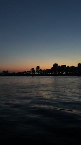 Dusk skyline captured over Kazan waterfront with crescent moon