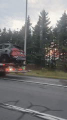 Burned-out SUV towed down highway near Saint-Pascal