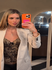 Woman takes bathroom mirror selfies in Berlin