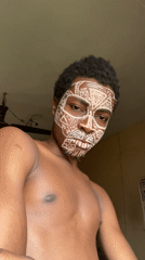 Young man displays traditional tribal face paint in Nkpor