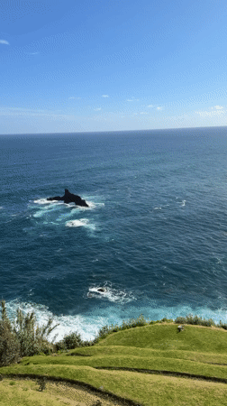 Tourists capture scenic coastal views at São Vicente, Portugal