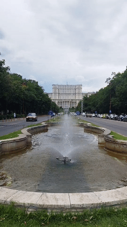 Bucharest avenue scene: fountain, traffic, and a bridal storefront