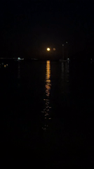 Full moon over a calm Mallorcan coast on a summer night