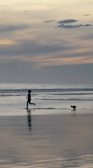 Families and dog walkers enjoy sunset beach time in North Kuta