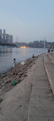 People gather along riverside embankment in Nan'an District