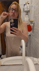 Woman brushes teeth while filming herself in Sochi bathroom