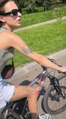 Cycling a sticker-covered bike along a Krasnoyarsk waterfront path