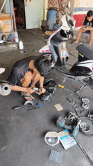 Busy scooter workshop in Silian Dua, multiple bikes being serviced