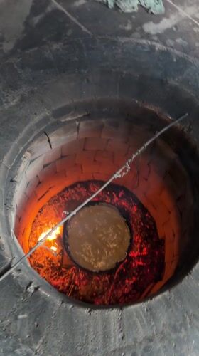 Traditional tandoor oven in operation in Arshaluys, Armenia