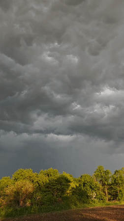 Storm clouds gather over rural Parkhomivka, Ukraine farmland