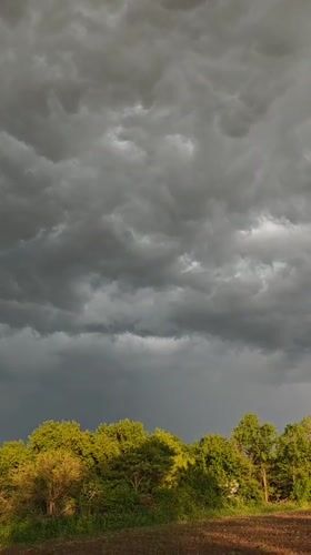 Storm clouds gather over rural Parkhomivka, Ukraine farmland