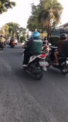 Busy afternoon motorcycle traffic across Larangan streets