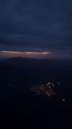 Dawn flight over Stuttgart captures city lights to sunrise transition