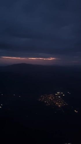 Dawn flight over Stuttgart captures city lights to sunrise transition