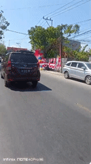 Street life and a green-domed mosque in Gorontalo, Indonesia