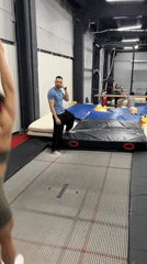 Woman practices gymnastics routine on trampoline in Moscow gym