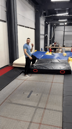 Woman practices gymnastics routine on trampoline in Moscow gym