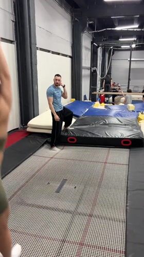 Woman practices gymnastics routine on trampoline in Moscow gym