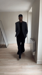 Person in business casual attire observed walking in Paris room