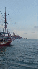 Tourist boats operate in Mersin harbor amid traditional dancing