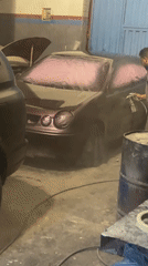 Car painting work documented in Marrakesh garage