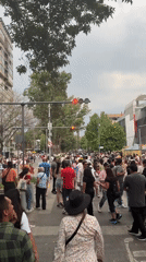 Evening pedestrian crossing captured near decorated Banamex building Mexico City