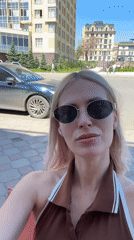 Woman films selfies amid Saratov's morning cityscape