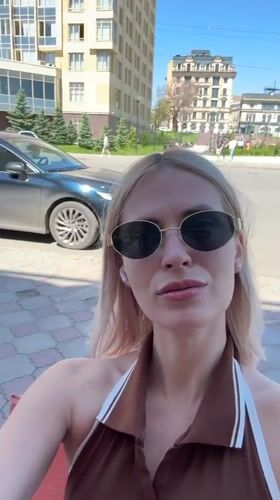 Woman films selfies amid Saratov's morning cityscape