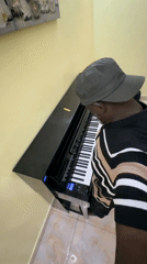 Man plays piano barefoot in Lekki home