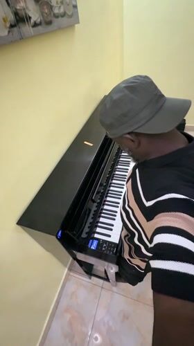 Man plays piano barefoot in Lekki home