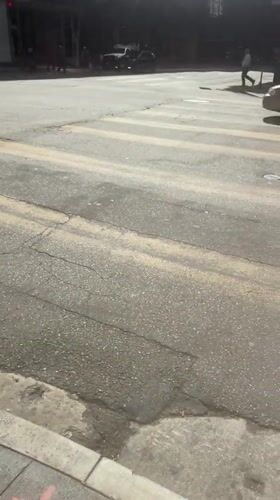 Person enjoys 85°C iced coffee on Hope Street sidewalk
