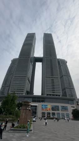 Tourists photograph Raffles City Chongqing's iconic twin towers