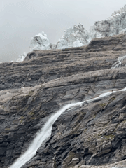 Glacier meltwater cascades down rocky slopes near Samagaon, Nepal