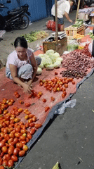 East Jakarta street market, vendors sorting and selling fresh produce
