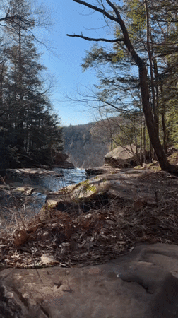 Two people walk cliff-side trail in Hunter, NY
