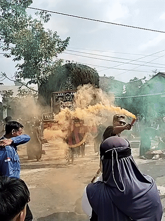 Traditional village performance with costumes and smoke in Ngadirejo