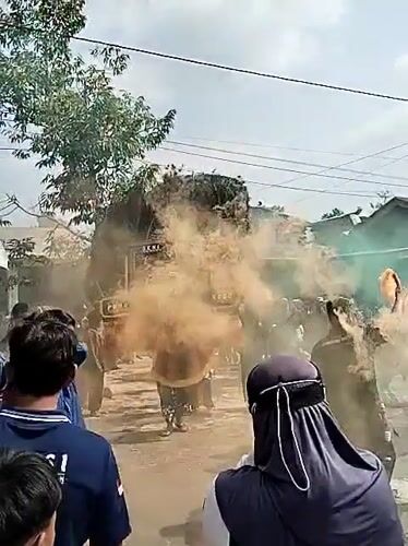 Traditional village performance with costumes and smoke in Ngadirejo