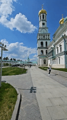 Woman walks near gold-domed building in Istra, Russia