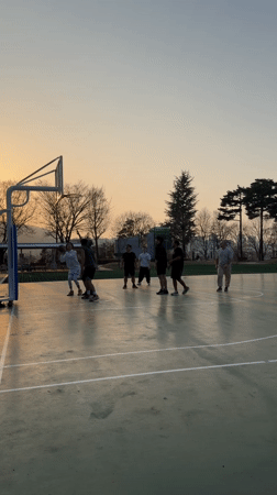 Men play sunset basketball in Daegu, South Korea