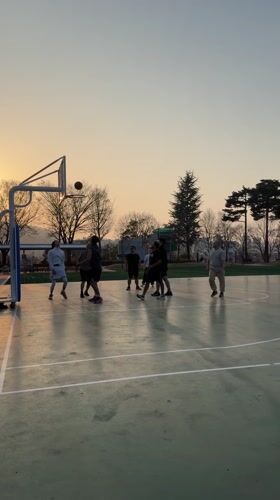 Men play sunset basketball in Daegu, South Korea